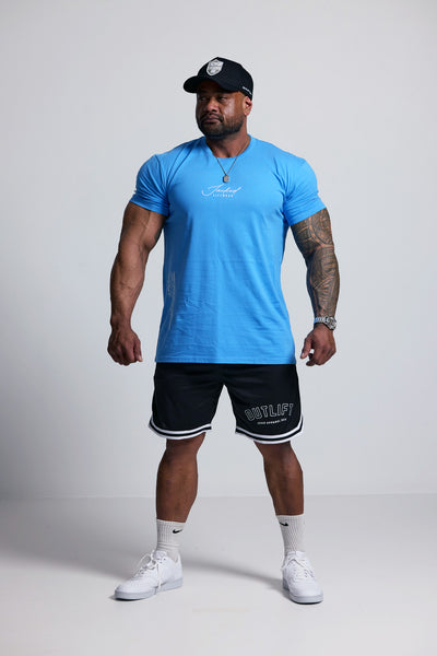 Man wearing a blue athletic shirt and black shorts on a white background