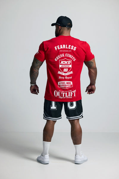 Person wearing a red t-shirt with branding and text, standing against a plain background